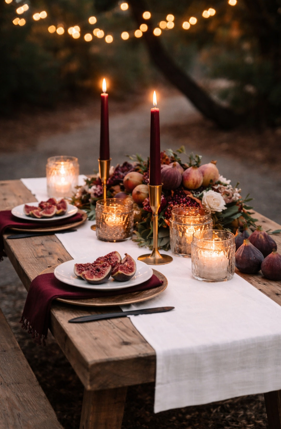 White linen table runner for dining table styled for autumn dinner party – rustic table styling with gold candle holders, burgundy napkins and floral centrepiece for wedding or special occasion décor