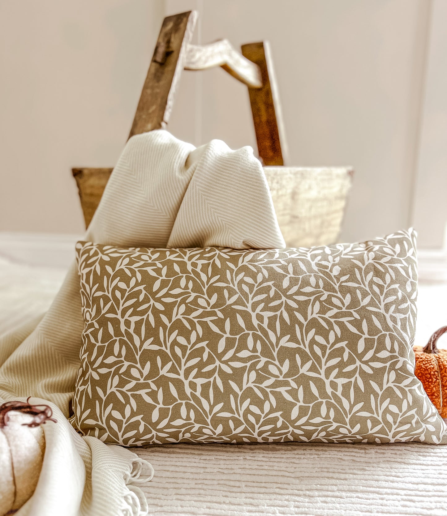 Decorative green cushions on a bed with a neutral color scheme