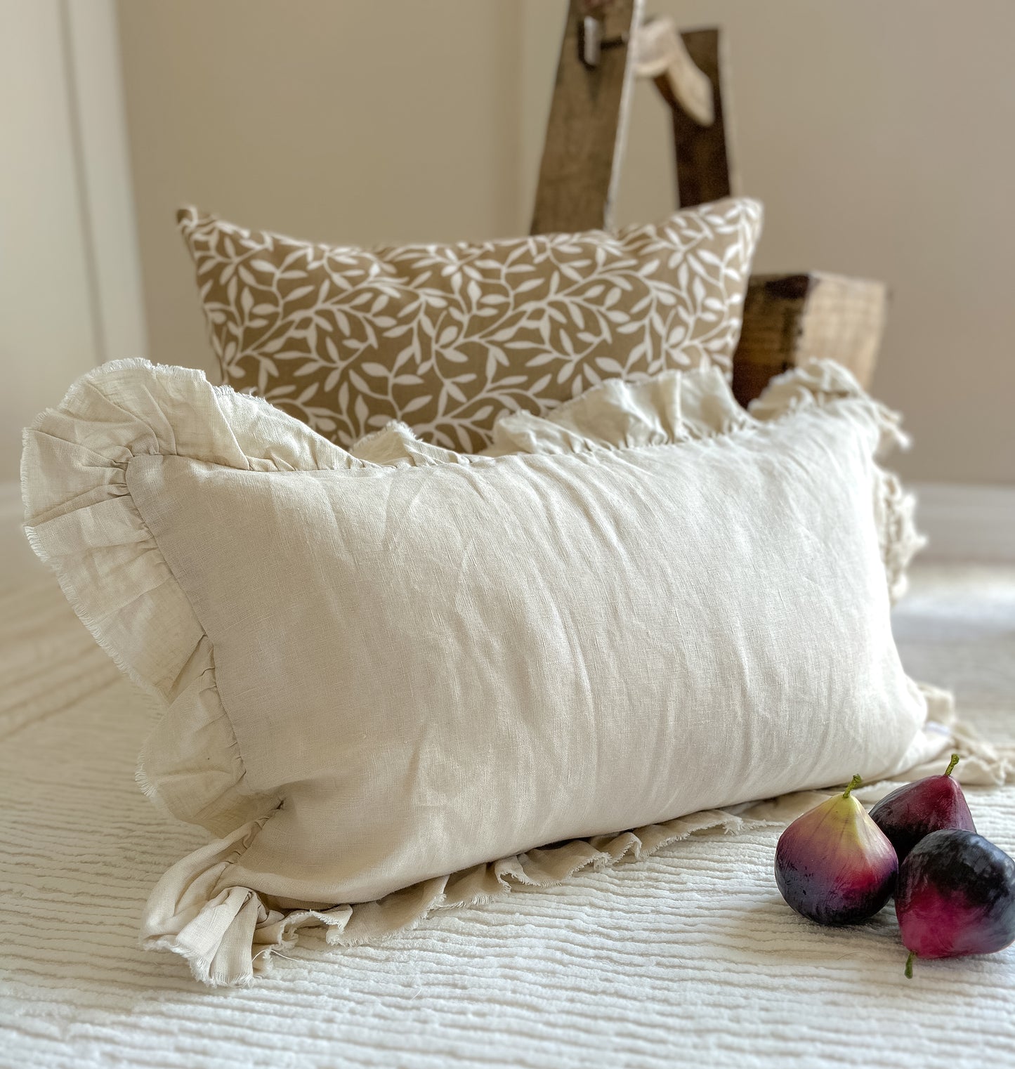 olive green cushion and neutral ruffled long cushion