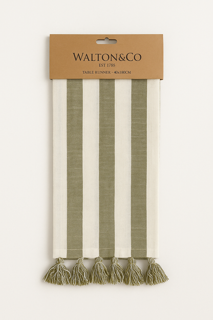 100% cotton table runner in olive green and cream stripes with hand-tied tassels, perfect for rustic or farmhouse-style tables.