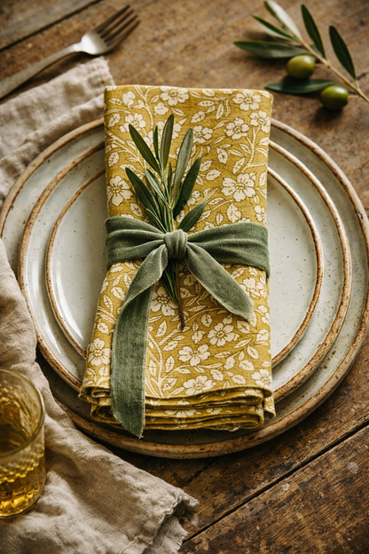 Set of four floral lemon cotton napkins styled on a summer table, soft yellow floral pattern, country garden table setting