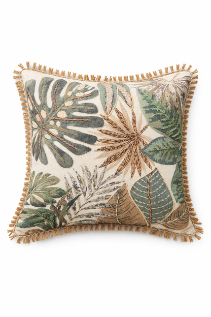 Decorative pillow with leaf pattern and tassels on a white background