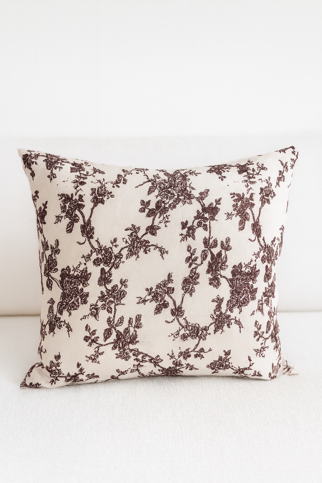 Decorative pillow with floral pattern on a white background