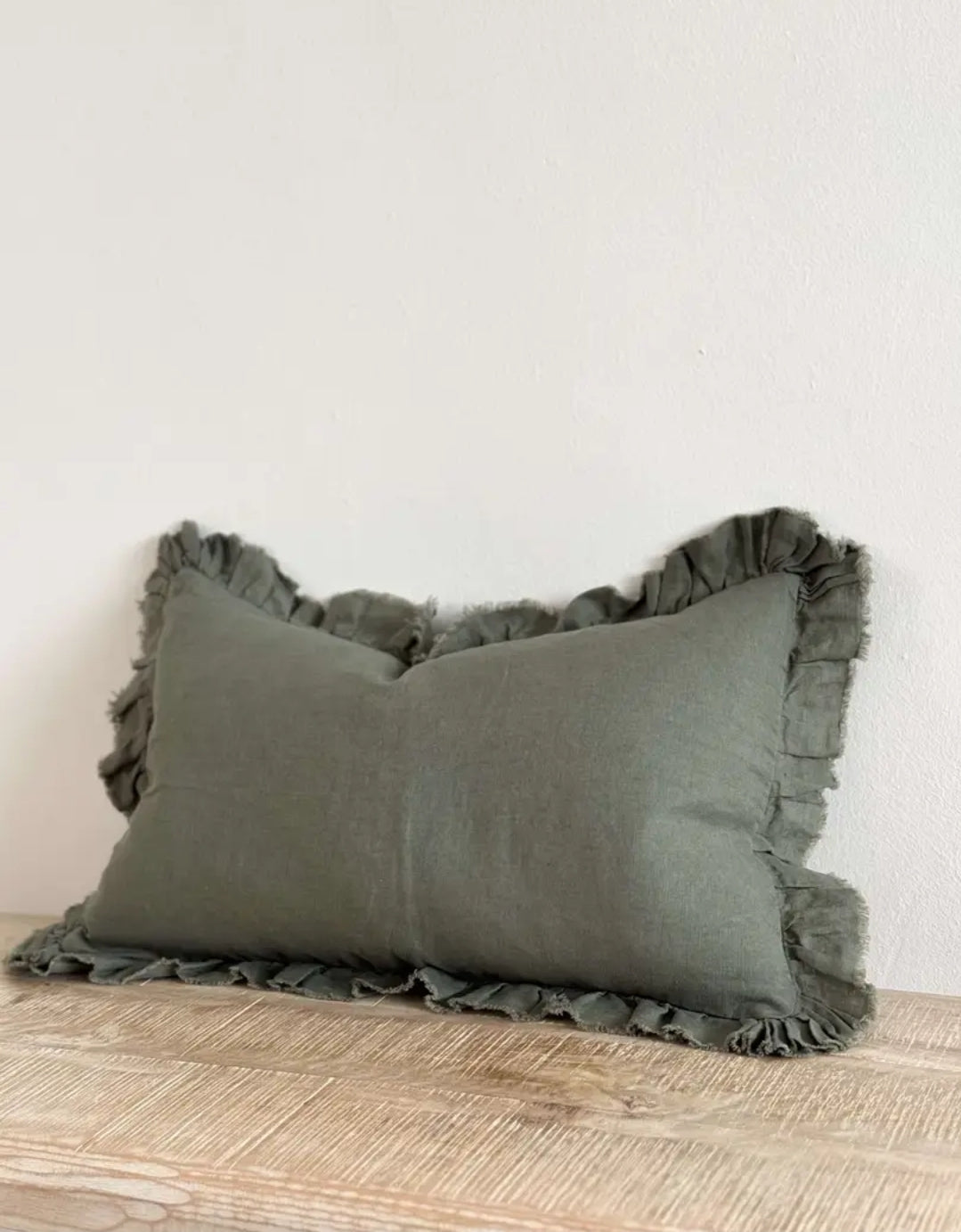 Rectangular 50 × 30 cm sage-khaki linen cushion cover with frilled edge—soft, neutral accent for bed or sofa.