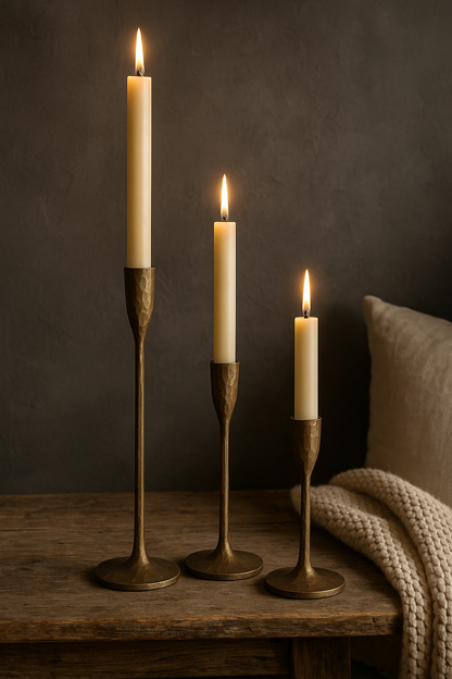 Set of three brass candlesticks in 42 cm, 32 cm and 22 cm sizes, elegant antique-style candleholders for cosy country cottage interiors in the UK & Ireland.