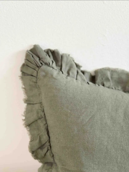 Stone-washed linen lumbar cushion cover in olive-khaki with ruffled edge, 50×30 cm—adds warmth to any room.