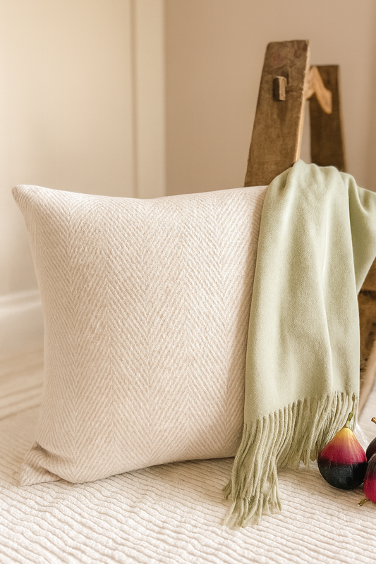 Lottie Herringbone Cushion in neutral tones on textured rug for cozy autumn home decor