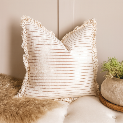 Linen rust ruffle cushion, machine-washable, styled with neutrals.